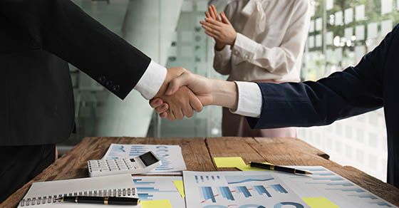 How will taxes affect your merger or acquisition? image of a handshake